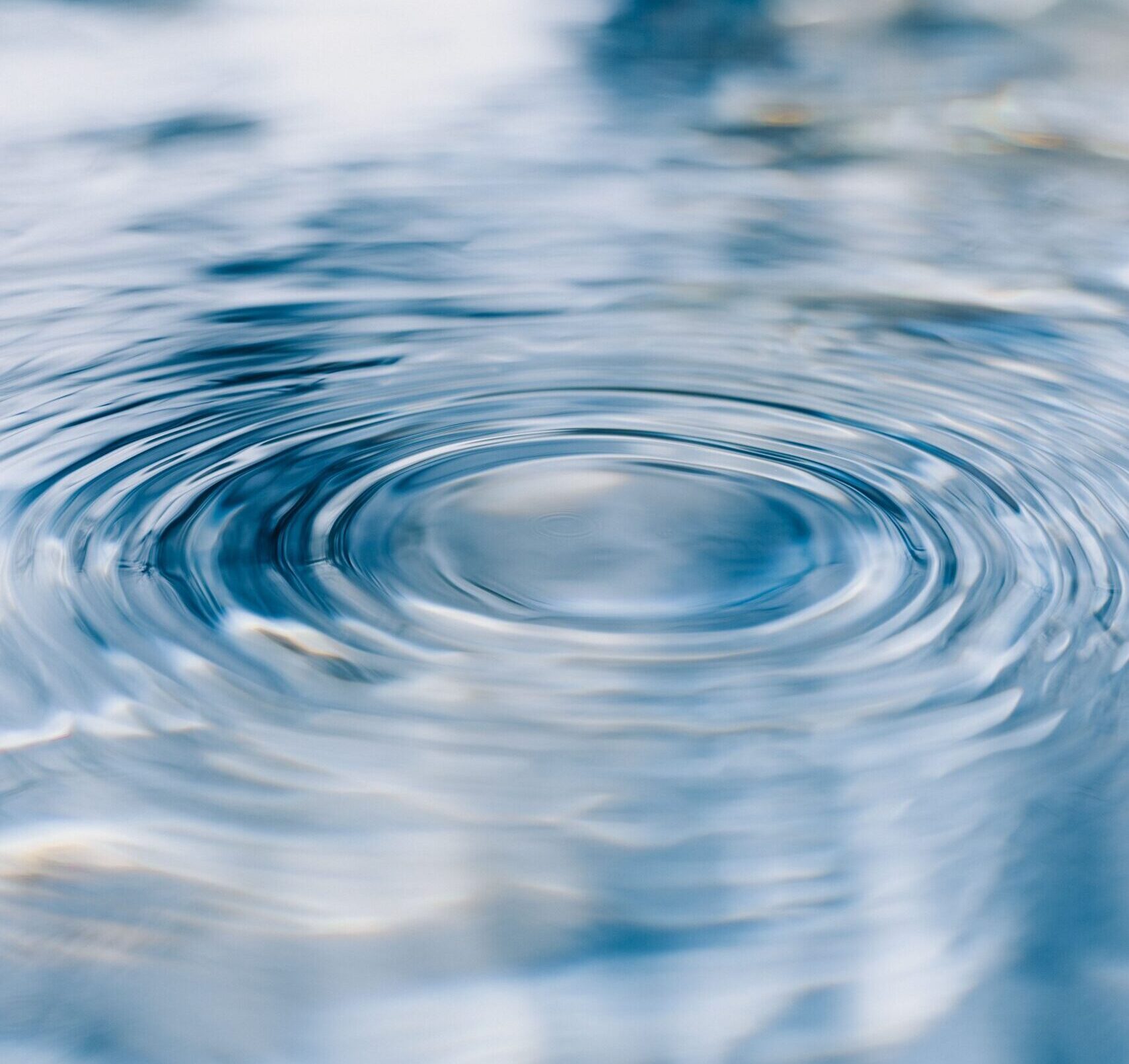 Concentric ripples spreading across the surface of water, symbolizing how reputation extends beyond individual guest experiences.