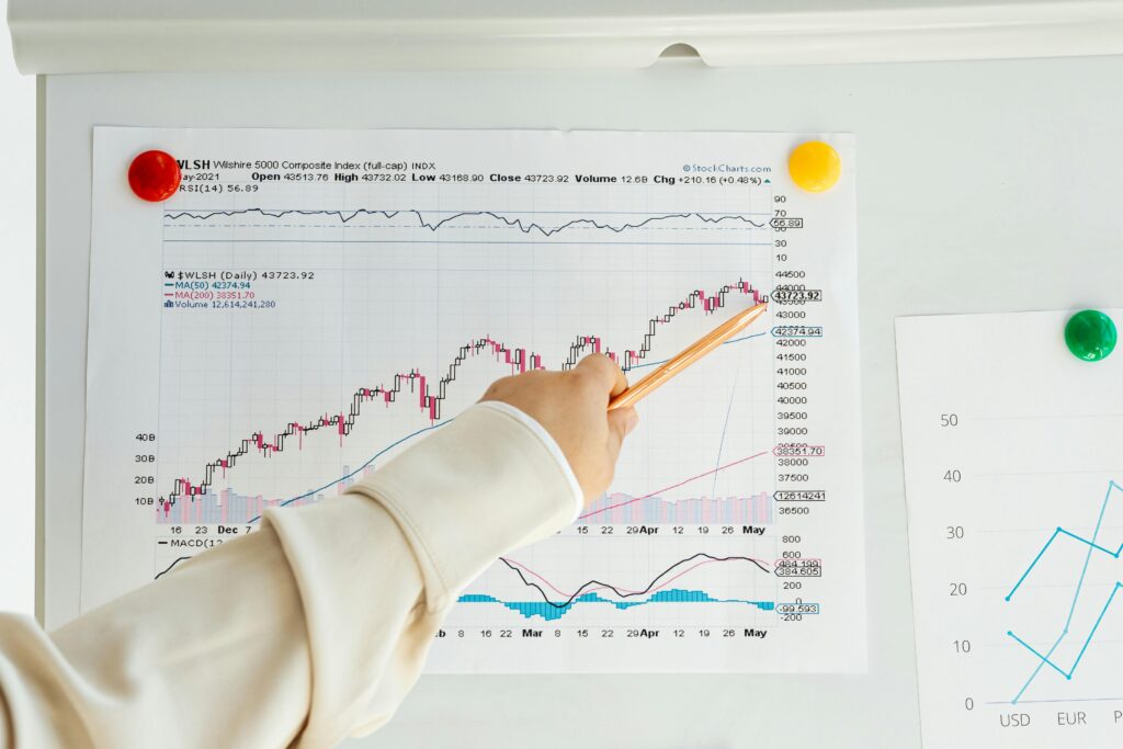 A hand presenting statistical results on a whiteboard, representing analytical revenue performance and decision structure.