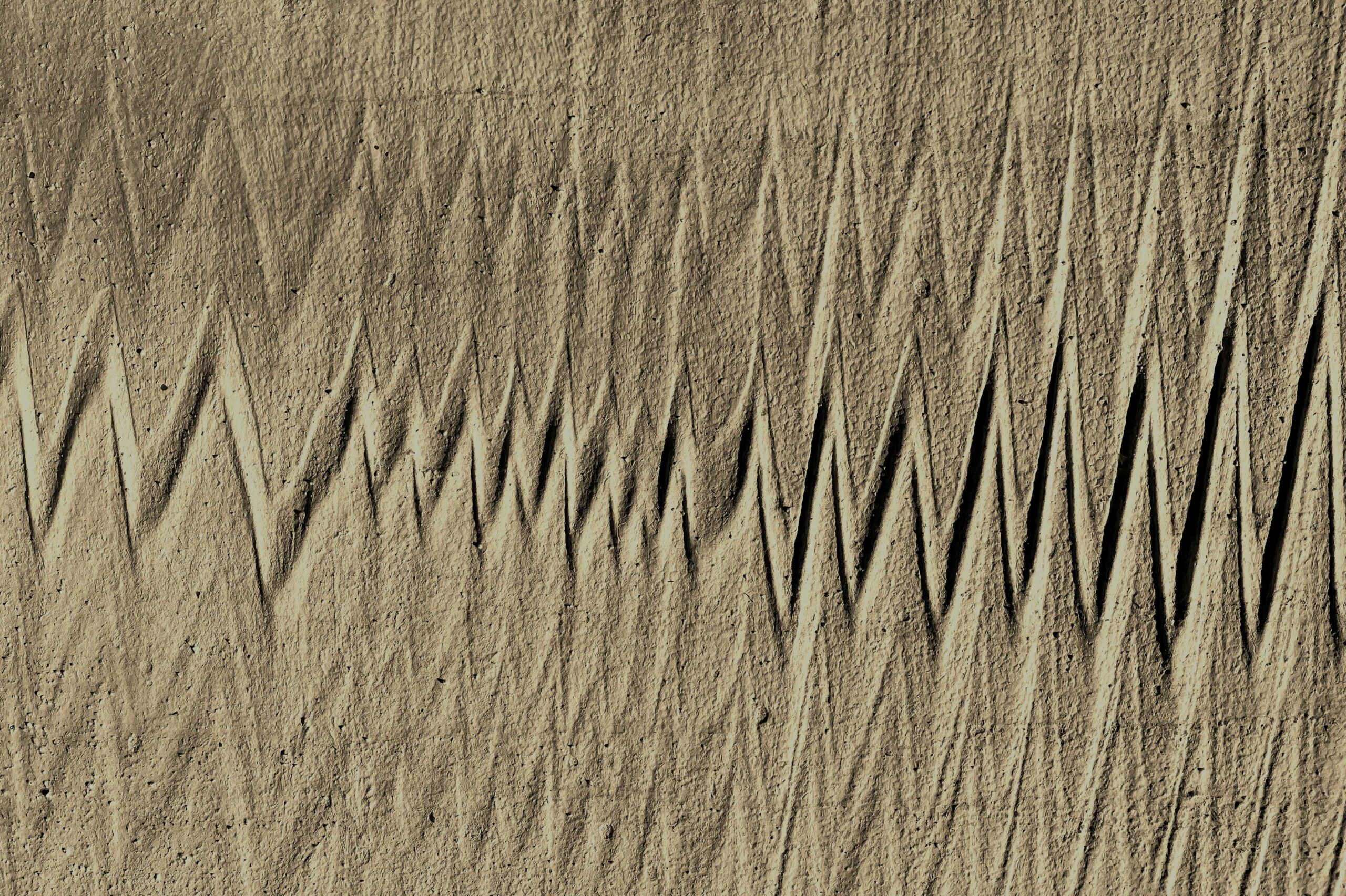 Fine ripples across sand illuminated by warm natural light.