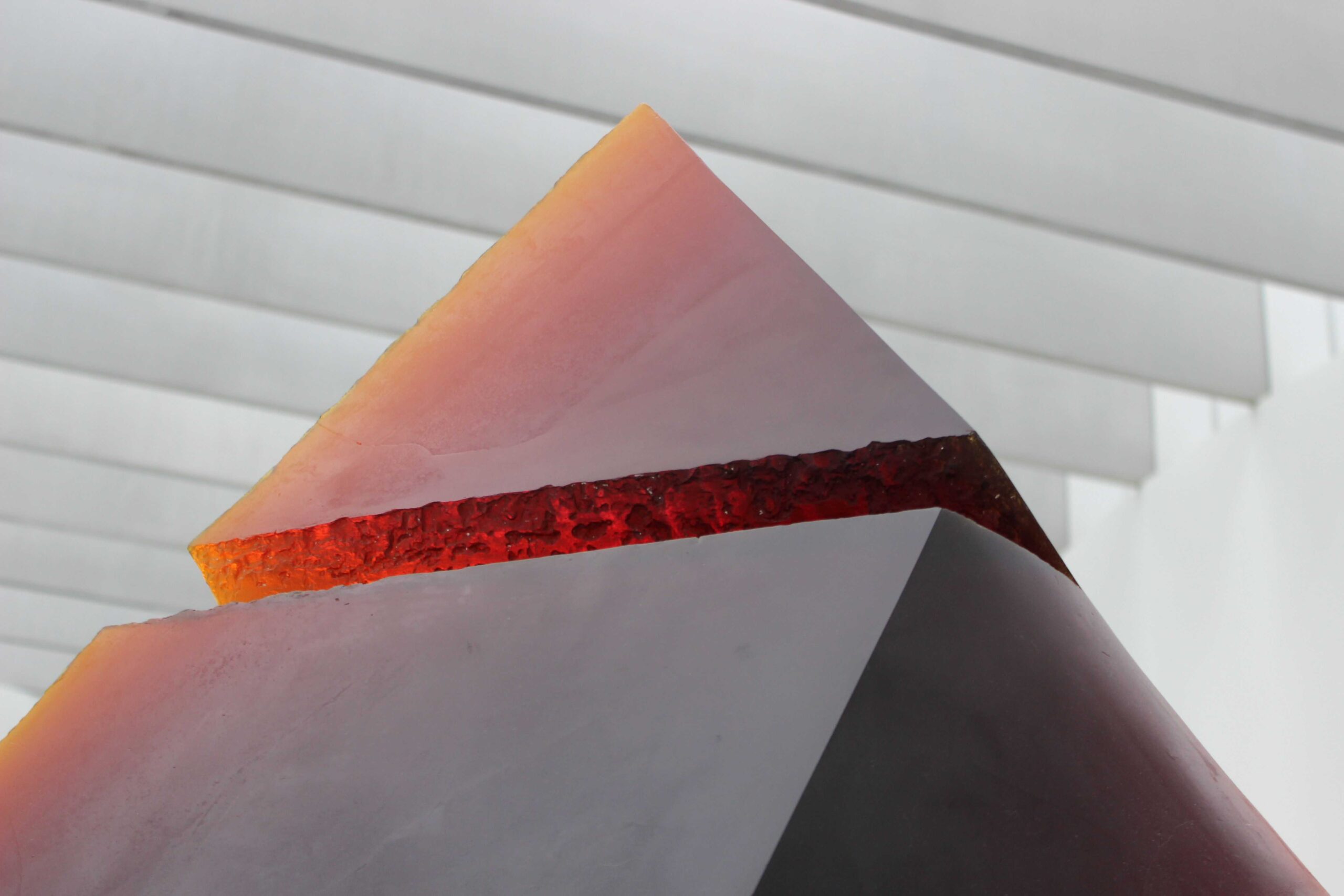 A geometric pyramid with its top section detached from the base.