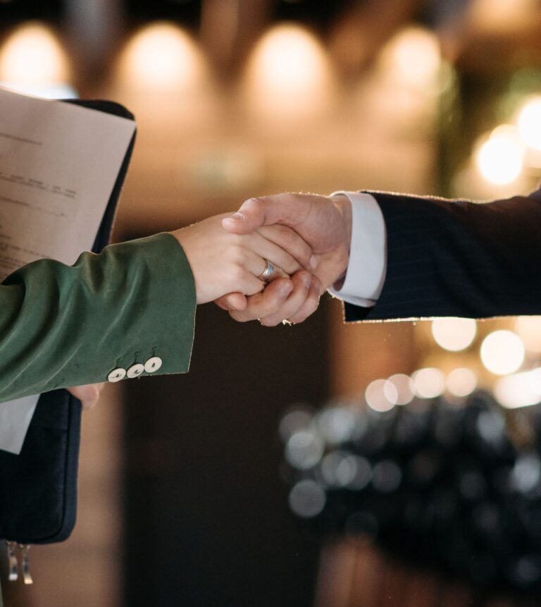 Handshake between hotel representatives symbolizing an ideal hospitality partnership.