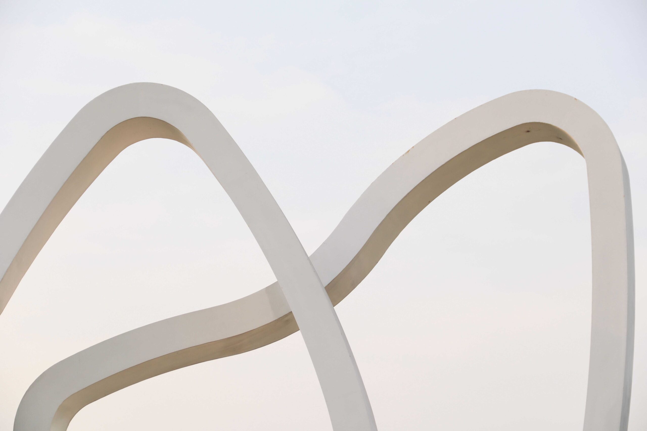 Two abstract lines gradually converging toward a common point.